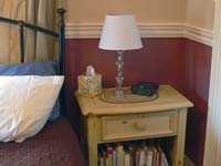 nightstand with lamp and books