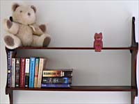 wall shelves with books and teddy bear